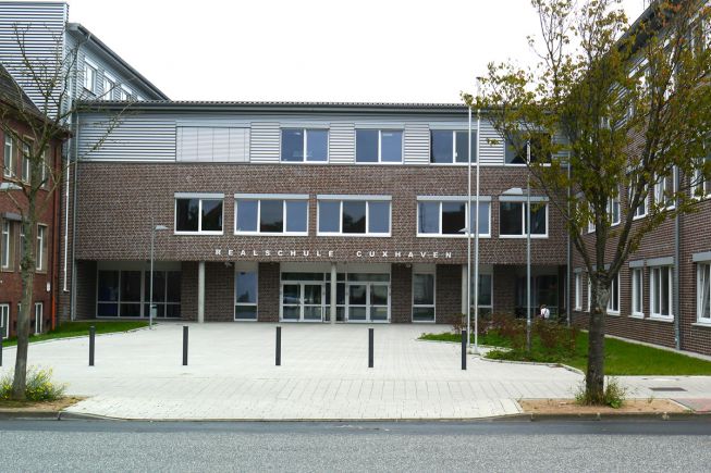 Der Neubau der Realschule wurde nach dem Entwurf des Bieters als direkte Erweiterung des Bestandes (Gebäude links) realisiert (Bild: VBD).